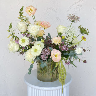 A soft floral arrangement filled with white and light pink flowers