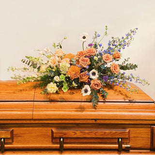 Floral casket spray atop a casket