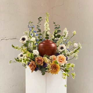 A ring of florals around an urn for a funeral