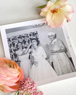 A photo of an old vintage photograph of three women on their wedding day