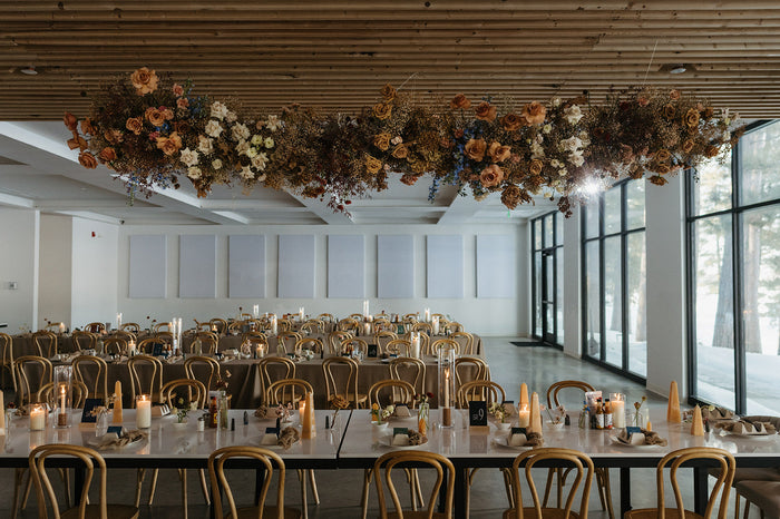 A hanging floral statement at a reception of a wedding
