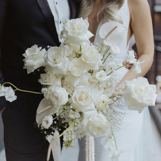 A large white floral wedding bouquet