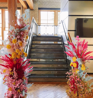 Large floral statements lining the staircase of an art museum